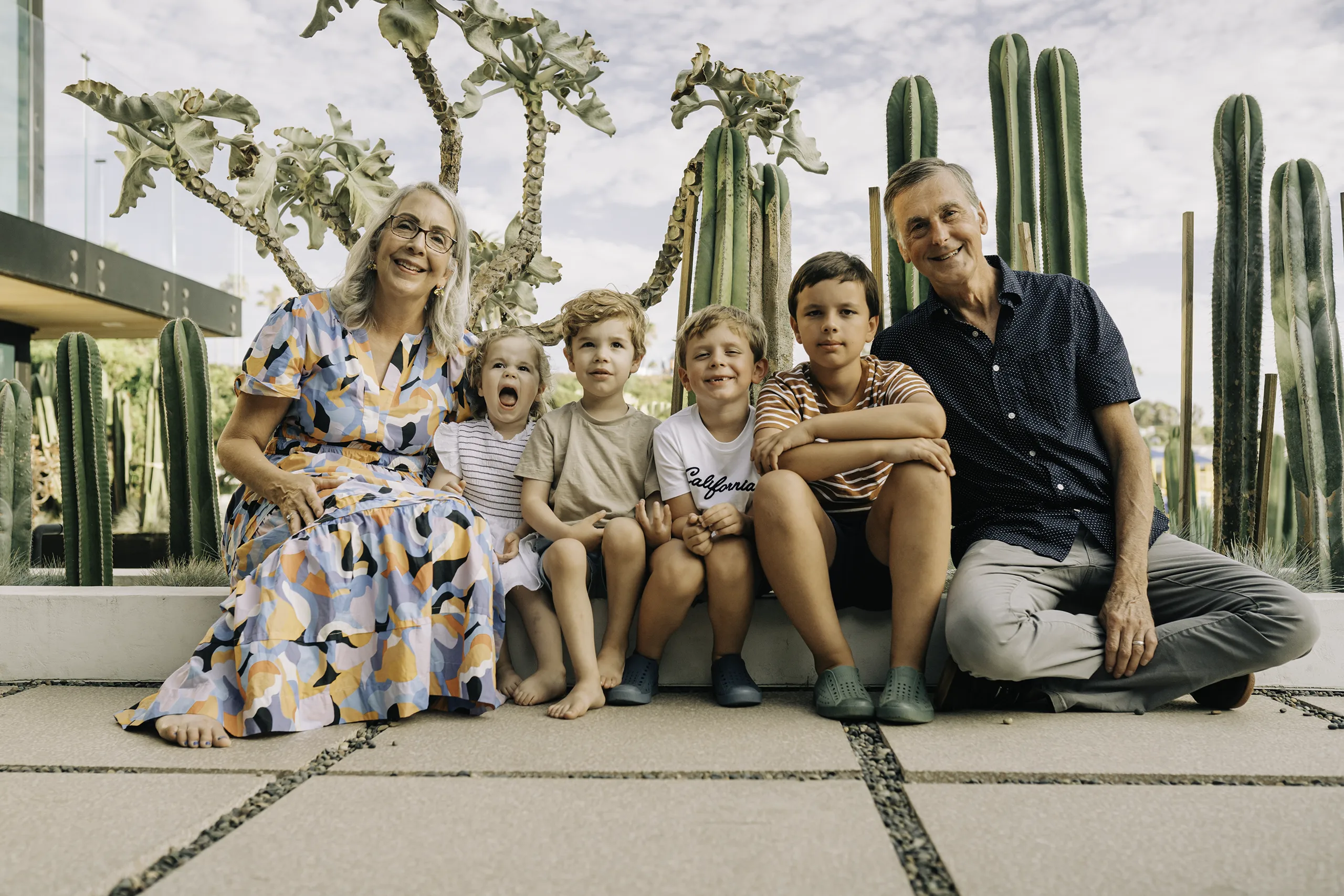 Grandparents sitting with grandkids with cacti as a background